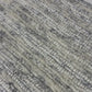Close-up of a patterned rug with a visible textures.