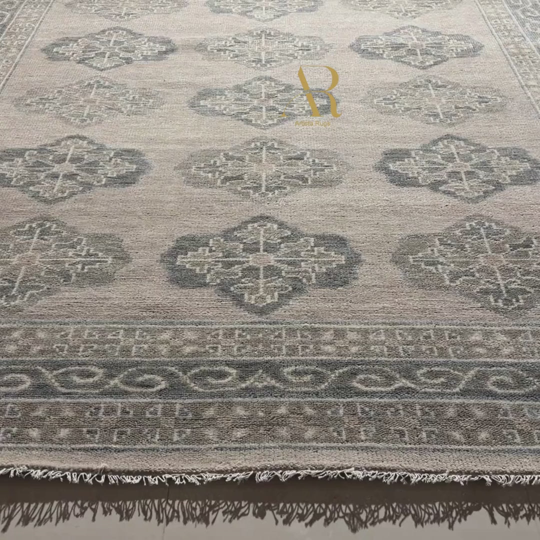 Textured fabric with intricate patterns in shades of gray and beige.