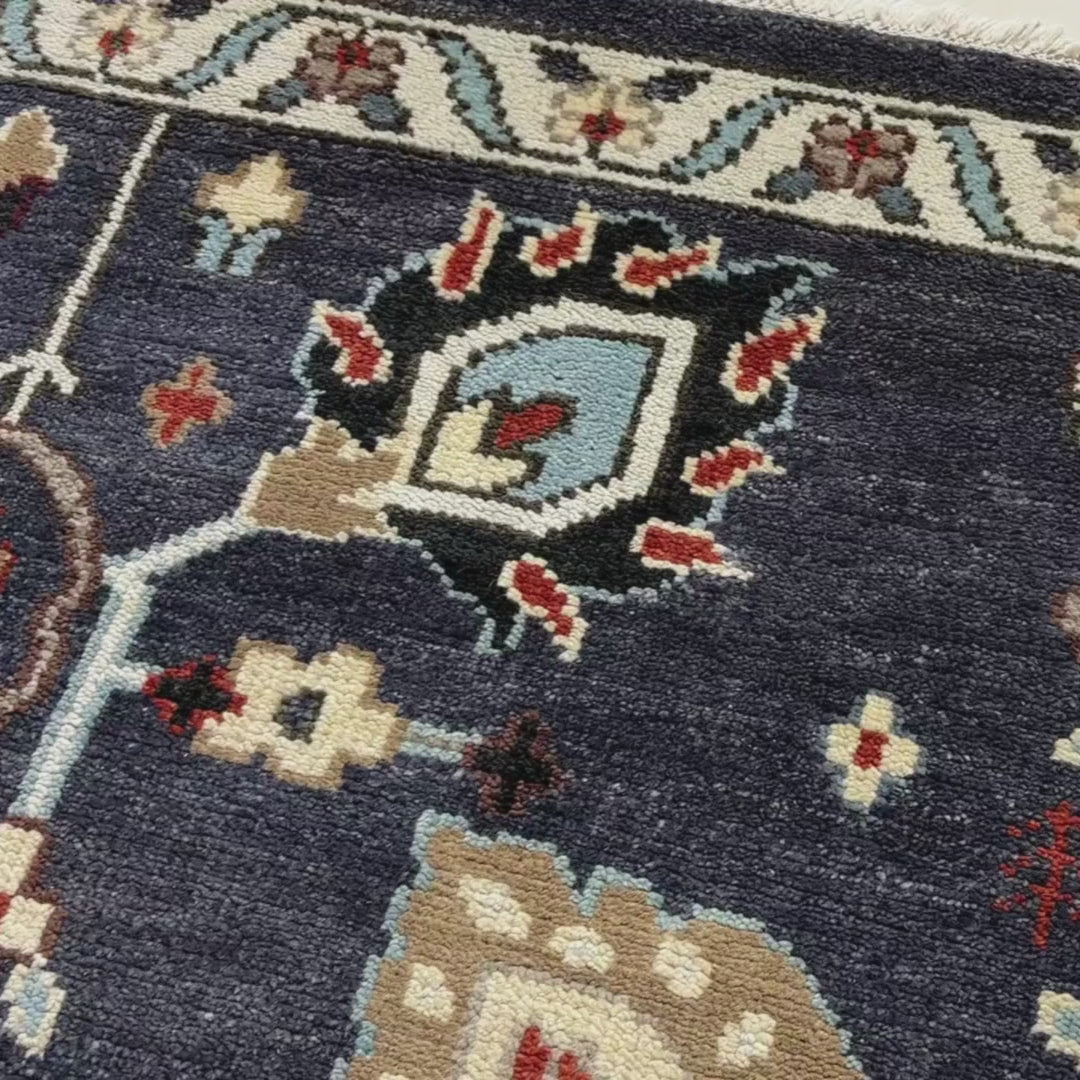 Close-up of a patterned rug with a visible textures.