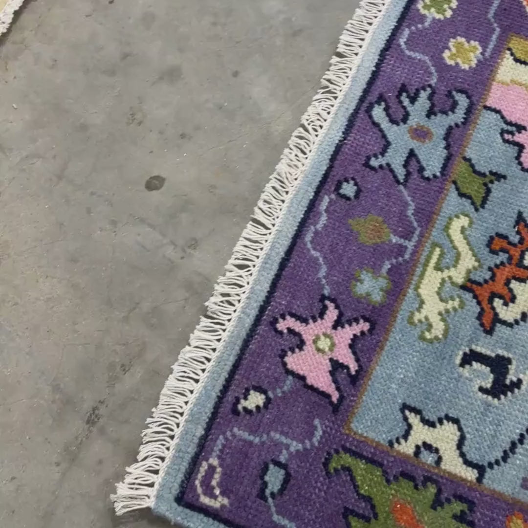 Colorful patterned rug with floral designs on a blue background